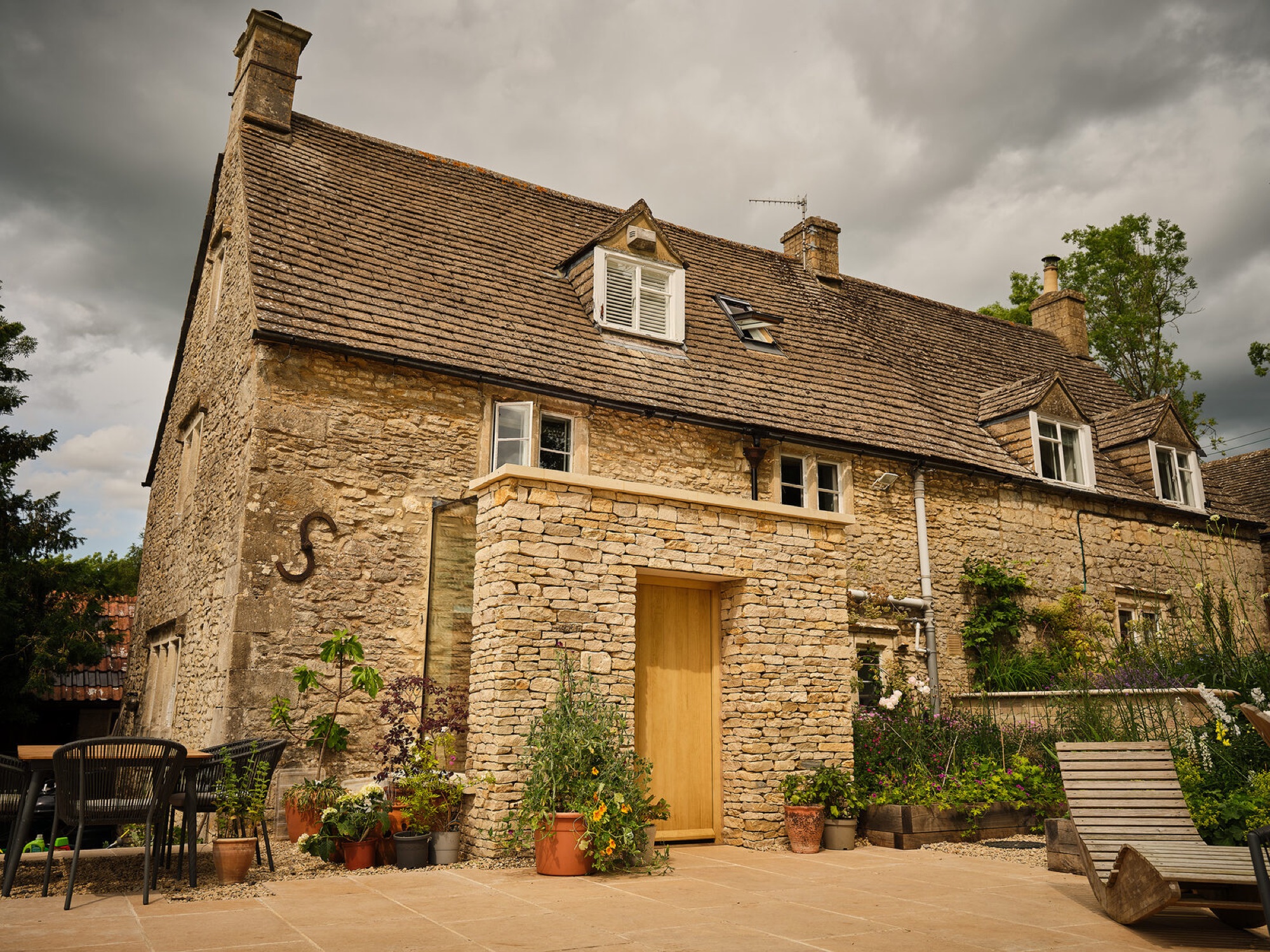 Contemporary glazed extension to a Cotswold stone house near Stroud