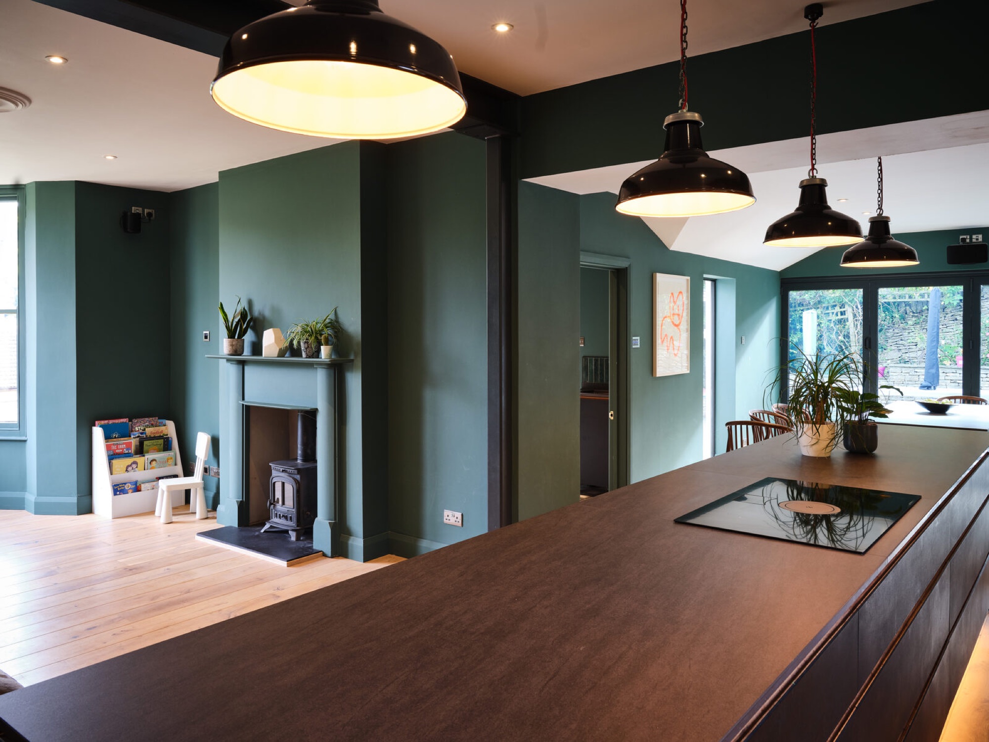 Deep green kitchen and timber island at The Old Manse in Nailsworth
