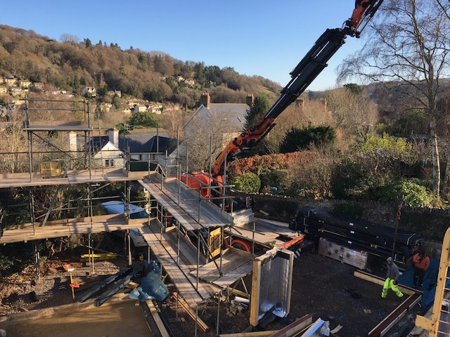 Crane installing structural elements at Hidden House