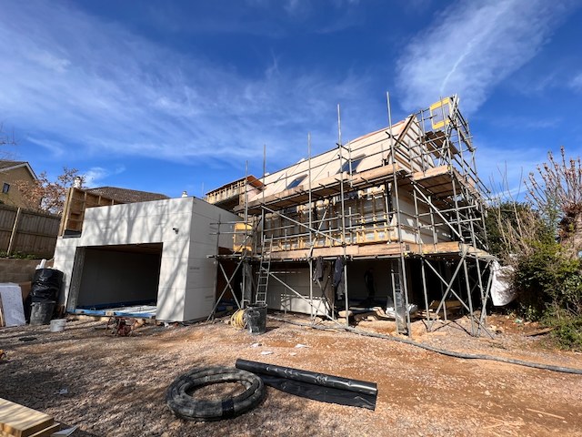 Hidden House exterior nearing completion with scaffolding