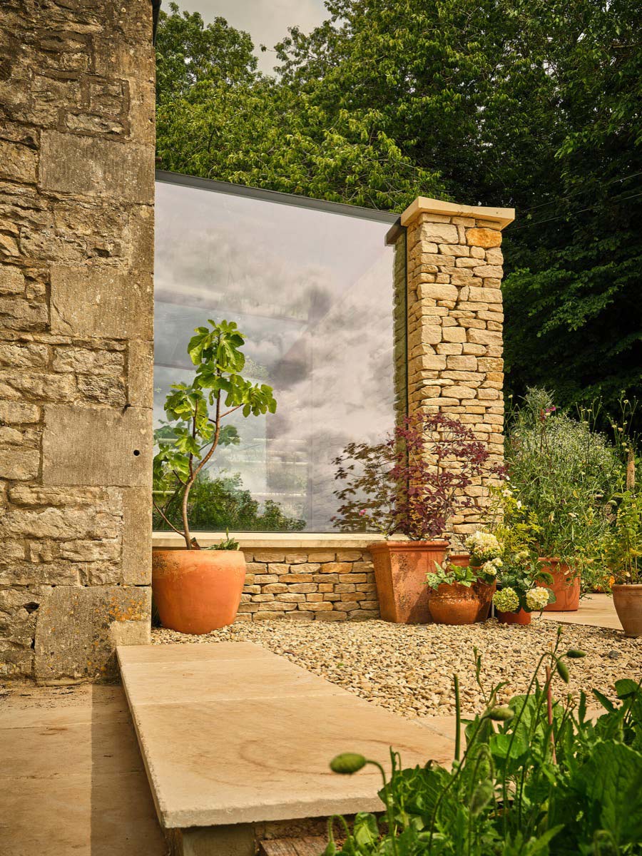 The new threshold — a courtyard moment that replaces the old, cramped porch.