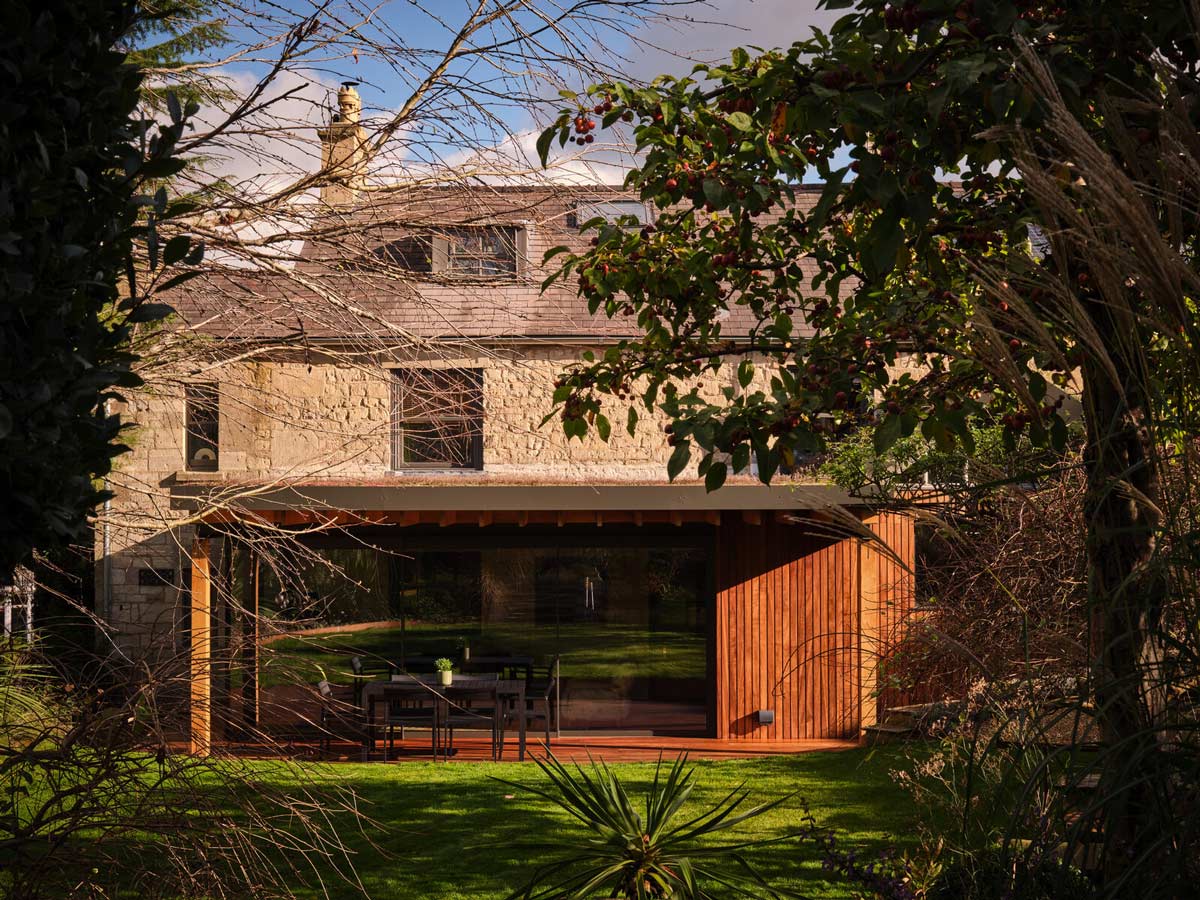 The new threshold — a courtyard moment that replaces the old, cramped porch.