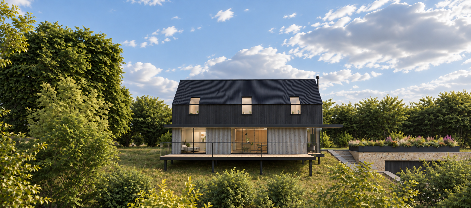 Highwood Cottage exterior with dark timber cladding, stone plinth and valley-facing terrace